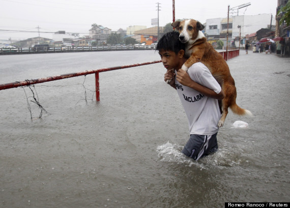 A boy carries his dog 