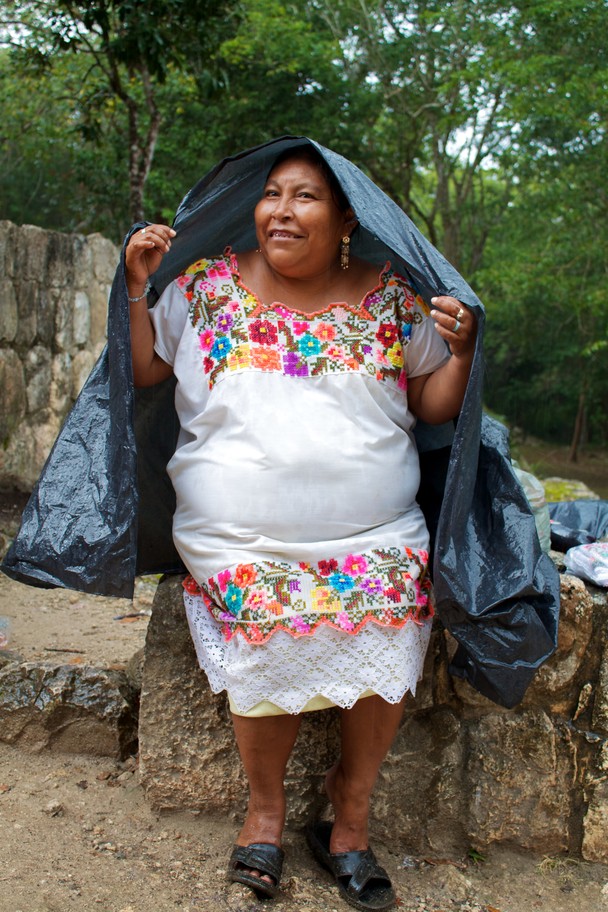 Mayan woman sheltering from the rain
