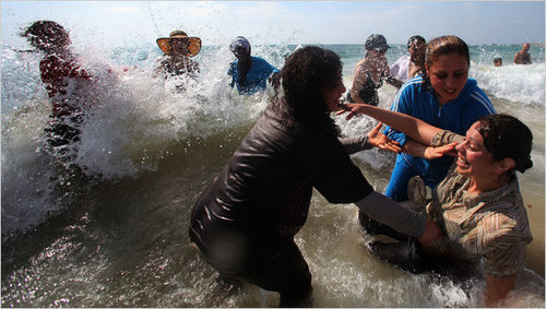 israeli and palestinian women swimming and splashing in the water - kindness