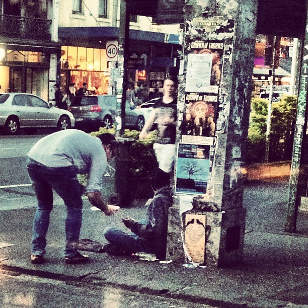 man helping a homeless person