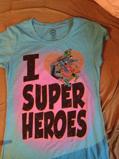 girl gives a boy a superheroes tshirt - kindness