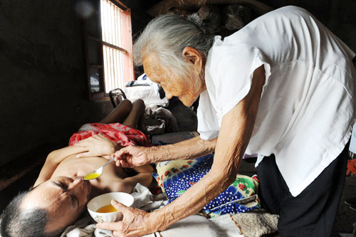 A 97 year old Chinese mother feeding and taking care of her 60 year old paralyzed son every day for over 19 years