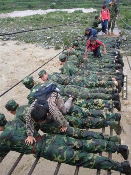 Faith in humanity restored. Chinese soldiers serving as a bridge to save people from recent floods.