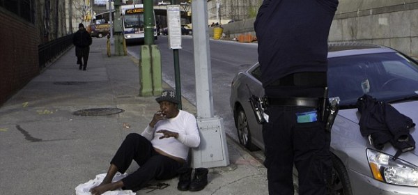 Warm heart: NYPD Transit Bureau officer Carlos Ramos stopped and gave Robert William a sweater off his back in the frigid New York morning on Friday