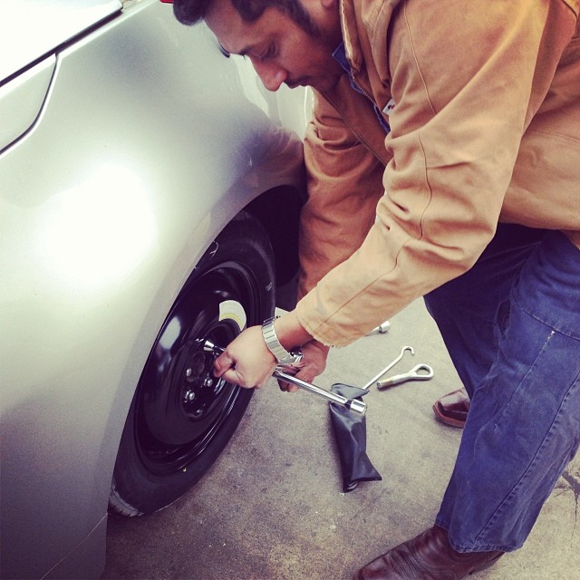 man changes a tire - random act of kindness