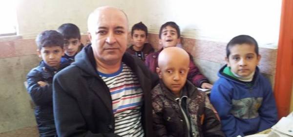 Ali Mohammadian and his pupils, who shaved their heads in solidarity with a bullied pupil