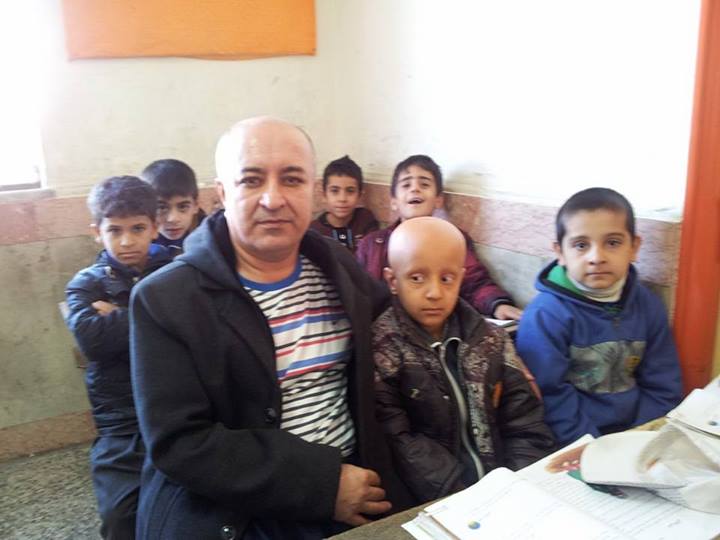 Ali Mohammadian and his pupils, who shaved their heads in solidarity with a bullied pupil