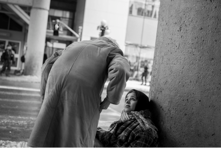 old lady giving scarf and money to homeless girl - kindness
