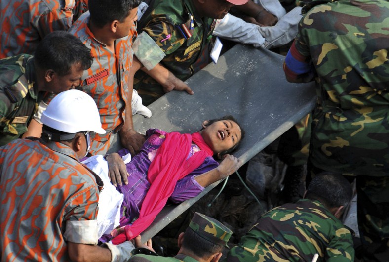 Rescuers pull out a female survivor, Reshma, alive 16 days after a garment factory building collapsed in Bangladesh.