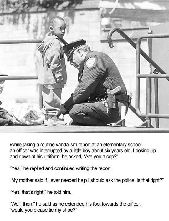 police officer ties a little boy's shoelaces
