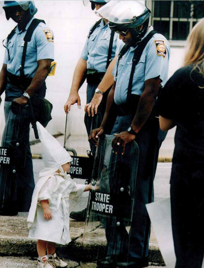 Child touches his reflection during a KKK demonstration [Georgia, USA, 1992]