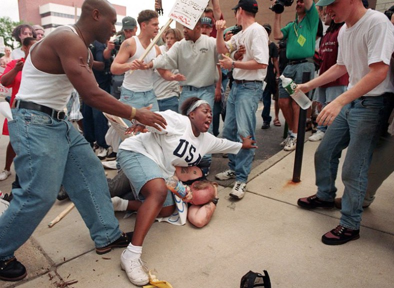 June 22, 1996 – Then 18-year-old Keshia Thomas of Ann Arbor shields a man wearing a Confederate T-shirt from an angry crowd during a Ku Klux Klan rally outside Ann Arbor’s city hall.