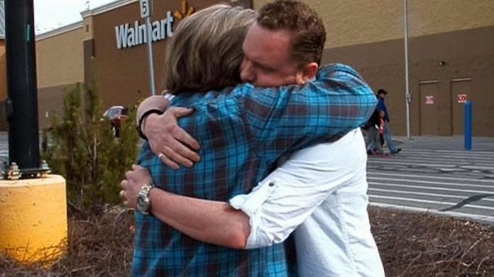 Daniel Smith receives a hug of gratitude from a stranger after giving her a Wal-Mart gift card. The gesture was part of Smith's Month of Happiness project. (Photo: courtesy Daniel Smith)