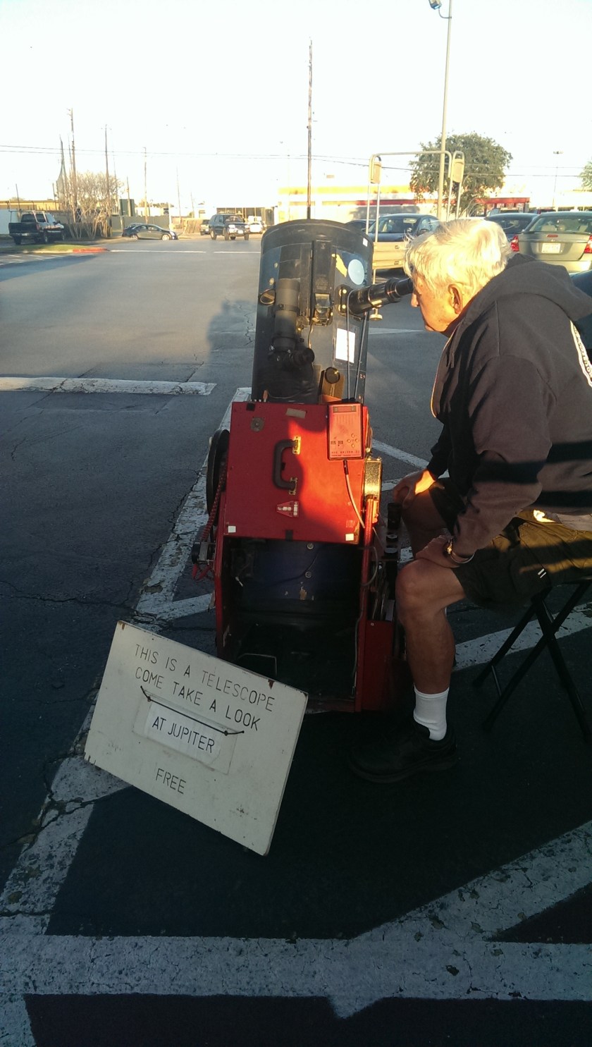 man offerws free look through his telescope