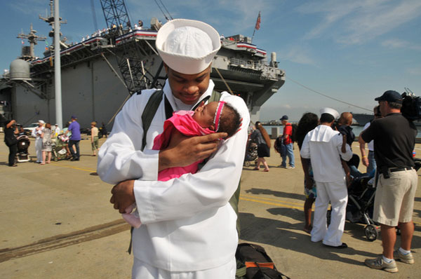 Sailor Demontay Blue meets his infant daughter.