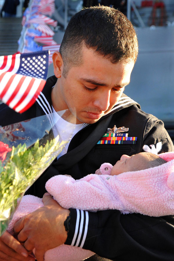 Sailor Stuardo Juarez meets his infant daughter.