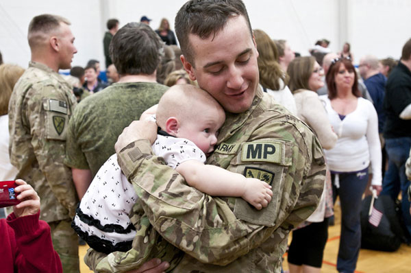 Specialist Ryan Tremble meets his 9-month-old daughter, Jade.