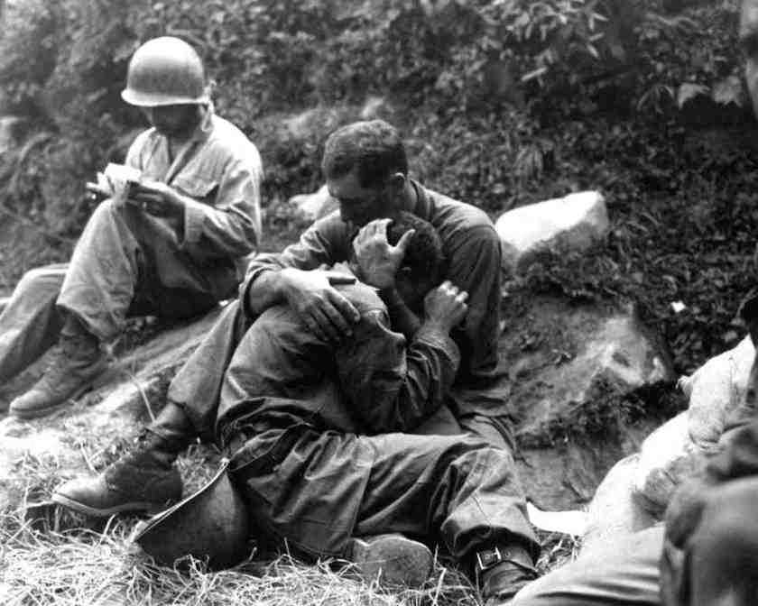 A grief stricken Infantry man in Korea is comforted by another soldier after his buddy died.