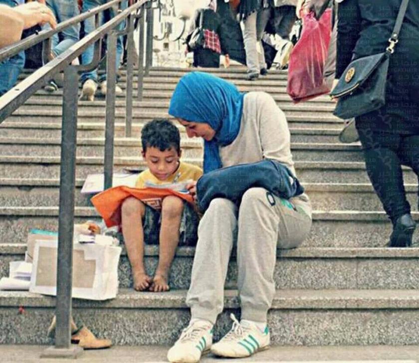 egyptian girl teaching homeless boy to read