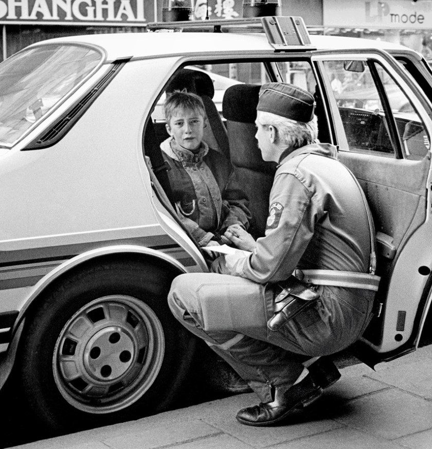 "Policeman comforts crying boy after he was hit by a car while skateboarding in Malmö, Sweden, 1986."