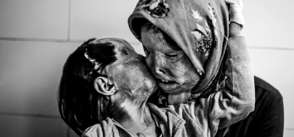 Somayeh Mehri (29) walks with her daughter Rana Afghanipour