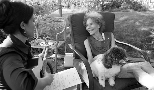 Merle Gross, age 73, a breast cancer patient, with Charla Burton in her backyard on the South Shore of Long Island, in Oceanside.