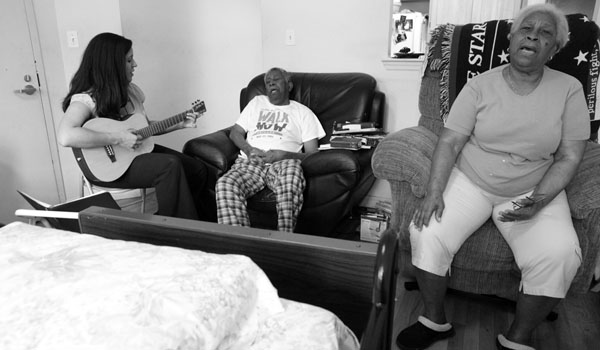 Ms. Burton visiting James D. Williams, 85, at his home in Brooklyn. He is terminally ill with prostate cancer. He and his wife of 61 years, Daphne, both love to sing hymns.
