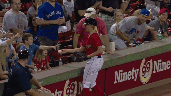  Boy hands souvenir over to girl behind him