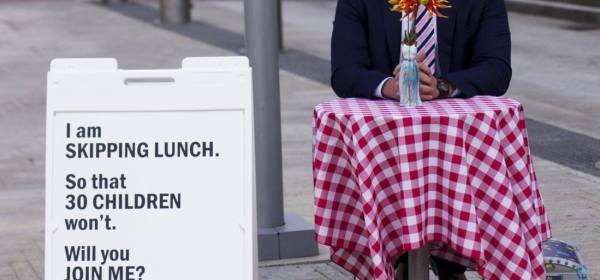 Portland man skips his lunch to raise money, awareness for Oregon Food Bank Anton Cobb, 32, sits alone in Director's Park during his lunch hour every Wednesday at a table decorated with a red and white checkered tablecloth.