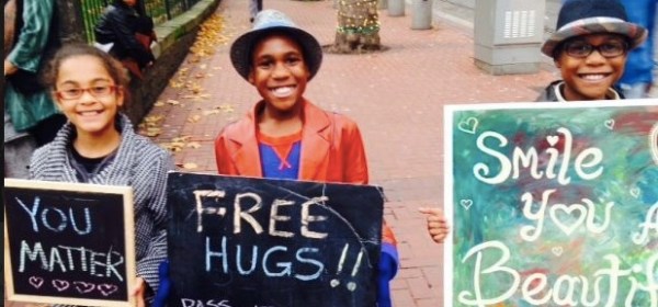 Devonte Hart, holding a “Free Hugs” sign