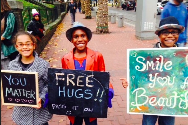 Devonte Hart, holding a “Free Hugs” sign