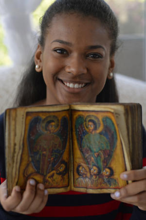 Nubia Wilson, 16, of Antioch, holds a 17th century Ethiopian Orthodox manuscript at her home in Antioch, Calif., on Sunday, Jan. 11, 2015. (Jose Carlos Fajardo/Bay Area News Group