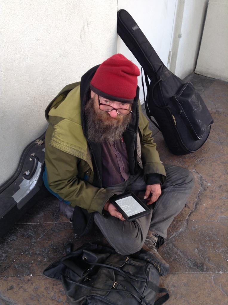 homeless man with a kindle
