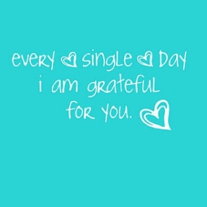 Light Blue Background With A Gratitude Quote in White Writing With A Heart