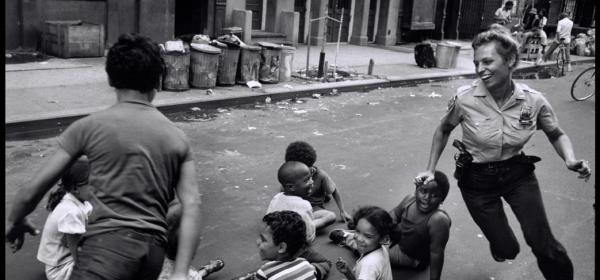 Police officers playing with children in Harlem, 1978