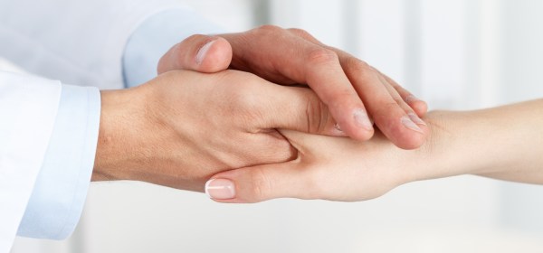 doctor holding patient's hand