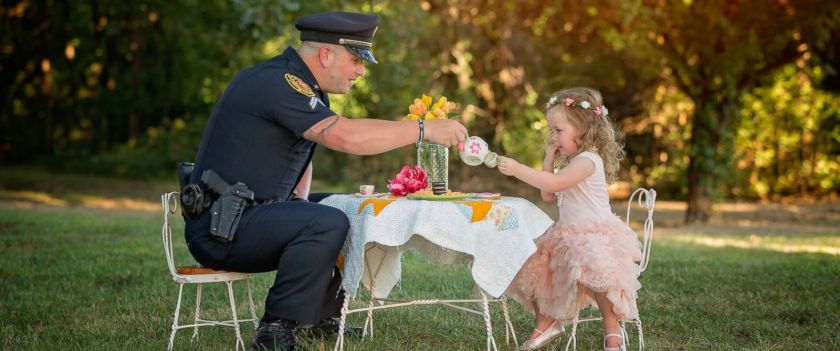 Little girl has tea party with police officer who saved her life after she choked on a coin