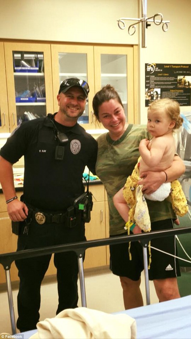 Reunited: Tammy Norvell, little Bexley and Officer Ray are pictured together in the hospital after the girl's close call