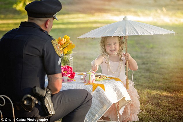 Guest of honor: The burly cop looked out of place sitting in a tiny chair at a miniature table, but he did not mind one bit