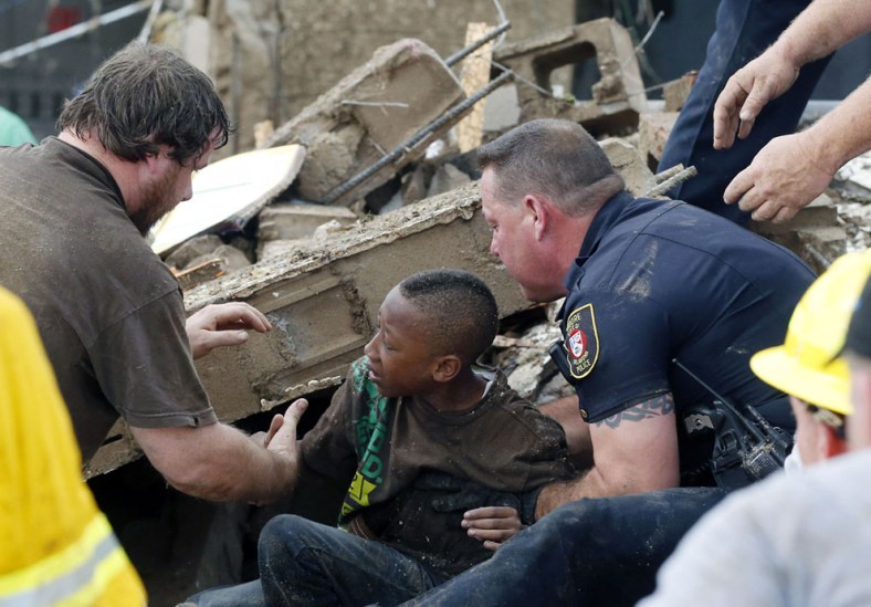 A boy is pulled from beneath a collapsed wall at the Plaza Towers Elementary School, on May 20, 2013.