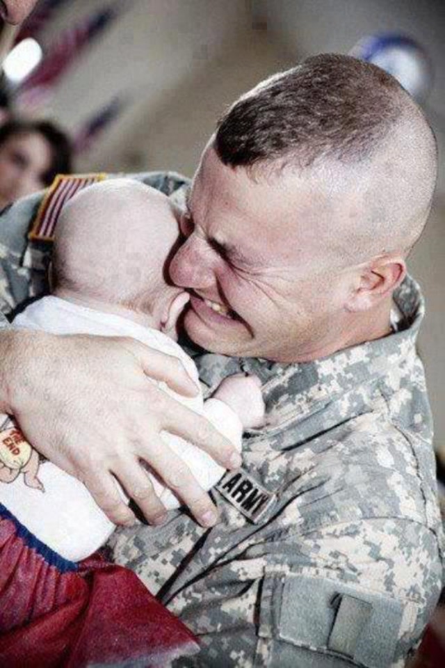 A touching moment. A U.S. Army soldier meeting his baby for the first time, after returning from Iraq.